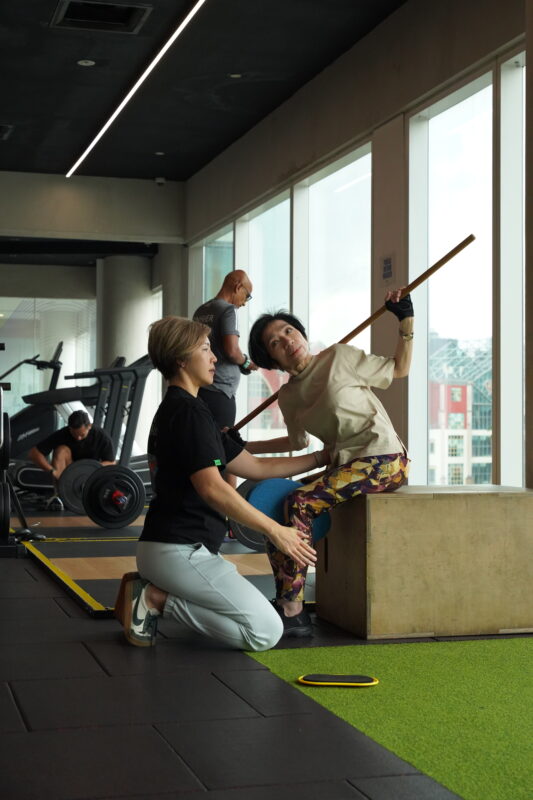 A member working through guided mobility for hips, shoulders and spine
